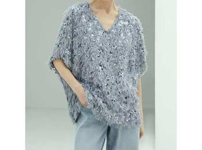 Pull en maille à sequins et pompons